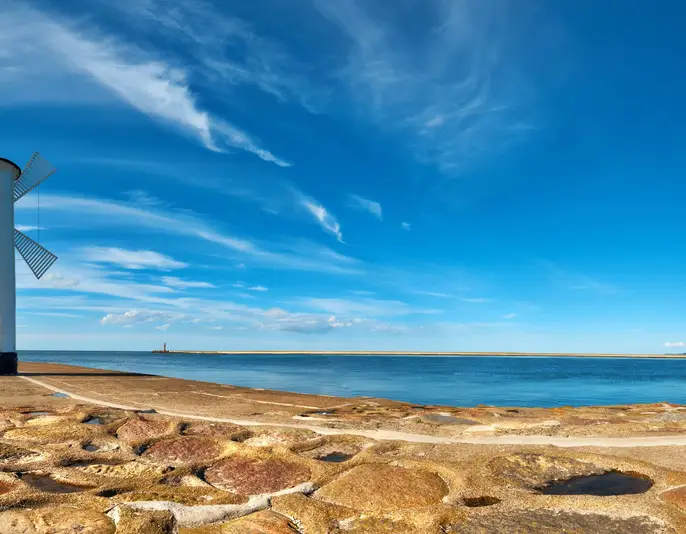 Panoramic image of an old lighthouse in Swinoujscie, a port in Poland on the Baltic Sea. The lighthouse was designed as a traditional windmill.