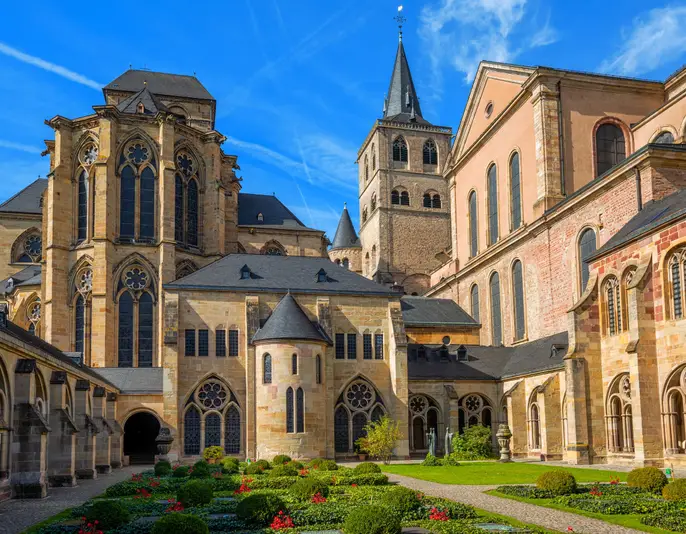 Historical romanesque and gothic style St Peter Cathedral in Trier, Germany, view from the cloister yard. The Cathedral is UNESCO world culture heritage site.